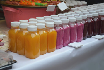 different types of smoothies are on display in a summer cafe in the street. to take off in market