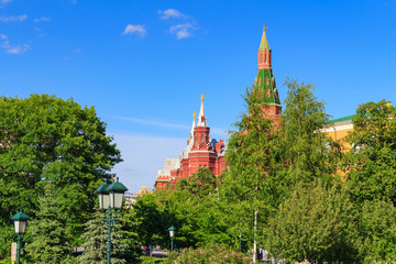 Tower of Moscow Kremlin and building of State Historical Museum against blue sky. View from Alexandrovsky Garden