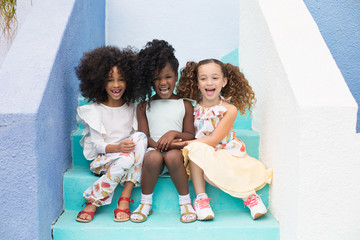 Cheerful friends sitting on steps