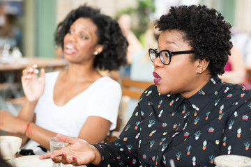 Businesswomen talking with colleagues in casual meeting