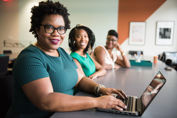Portrait of smiling businesswomen sitting in the office