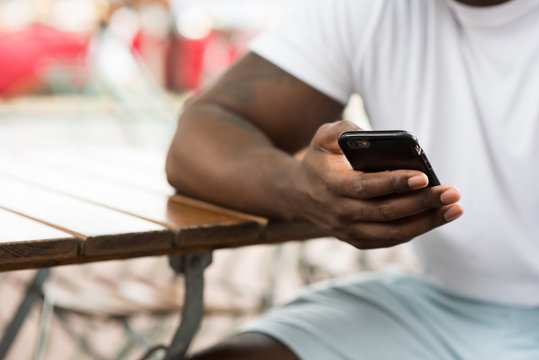 Mid section of man using smartphone