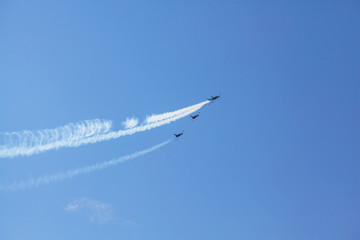Squadron of air transport high in the sky makes a demonstration performance at the air show. Bottom view of the group of aircraft. A group of sports aircraft gaining altitude.