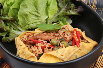 Omelet fried spicy basil with pork,eggplant,lentils,acacia  ,chili and curry topped mixed vegetable.