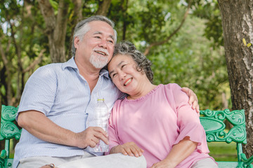 Happy elderly couple with lifestyle after retiree concept. Lovely asian seniors couple embracing together in the park in the morning.