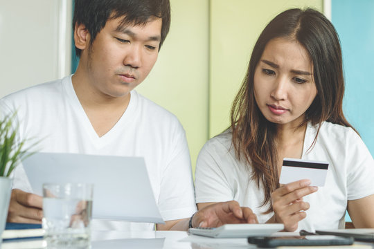 Family Financial Crisis. Stressed Young Asian Couple Looking At Issues Notification From Bank About Late Payment Home Loan Credit.