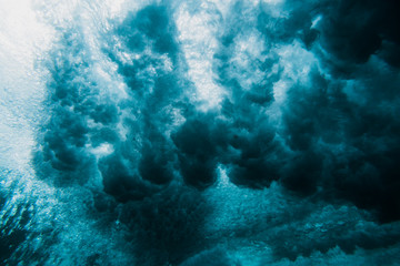 Fototapeta na wymiar Barrel wave underwater. Blue ocean in underwater