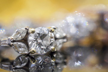 Naklejka na ściany i meble Luxury gold Jewelry diamond rings with reflection on black background