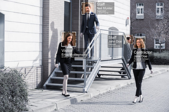 Businesspeople Walking Outside Office Building - Powered by Adobe