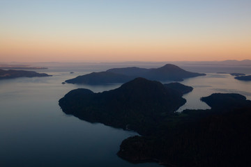 Fototapeta premium Aerial view of Howe Sound during a vibrant sunset. Taken North of Vancouver, British Columbia, Canada.