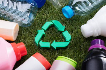 High Angle View Of Green Recycle Symbol On Grass