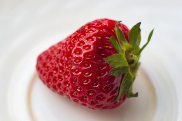 fresh ripe strawberries on black ceramic plate