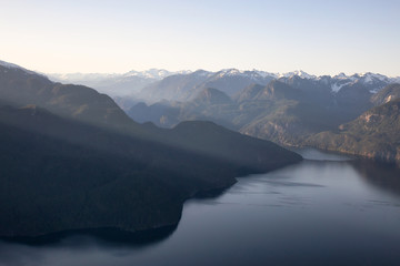 Obraz premium Striking Aerial View of the Canadian Mountain Landscape during a vibrant sunny day. Taken at Pitt Lake, North of Vancouver, British Columbia, Canada.