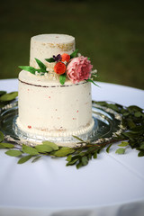 White Naked Layered Wedding Cake with Pink Peony and Roses on a Silver Platter