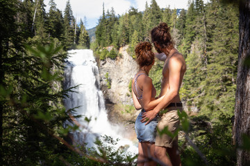 Young couple enjoying the time spent togheter in the nature. Taken in Alexander Falls near Whistler and Squamish, North of Vancouver, British Columbia, Canada.