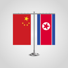 Table stand with flags of China and North Korea.Two flag. Flag pole. Symbolizing the cooperation between the two countries. Table flags