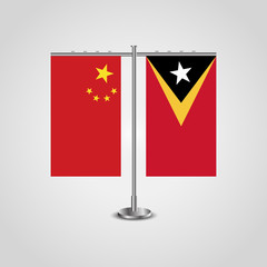 Table stand with flags of China and East Timor.Two flag. Flag pole. Symbolizing the cooperation between the two countries. Table flags