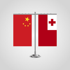 Table stand with flags of China and Tonga.Two flag. Flag pole. Symbolizing the cooperation between the two countries. Table flags