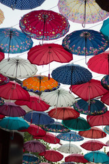 Colorful roof of rainbow umbrellas in the street