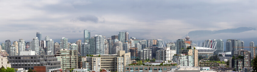 Fototapeta na wymiar Vancouver, British Columbia, Canada - May 18, 2018: Panoramic view of Developed Downtown City during a cloudy morning.