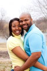 Fototapeta premium Happy African American couple hugging outside.