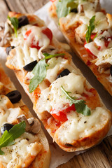 Hot sandwich casserole pizza with chicken, mozzarella cheese, tomatoes and mushrooms close-up. vertical