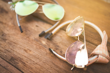 Summer accessories on wooden floor. Top view and copy space, picturesque, glasses and headband. Mock up and fashion and beauty.