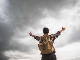 Fototapeta na wymiar A man travel outdoor nature with storm cloudy background.