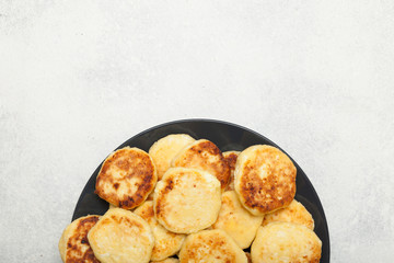 Traditional russian breakfast cheesecake, pancakes. Copy space for text.