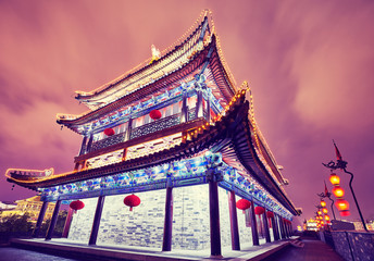 Xian city wall ancient building at night, color toned picture, China. © MaciejBledowski