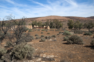 Kanyaka South Australia, arid landscape with abandoned shearing shed and quarters in distance