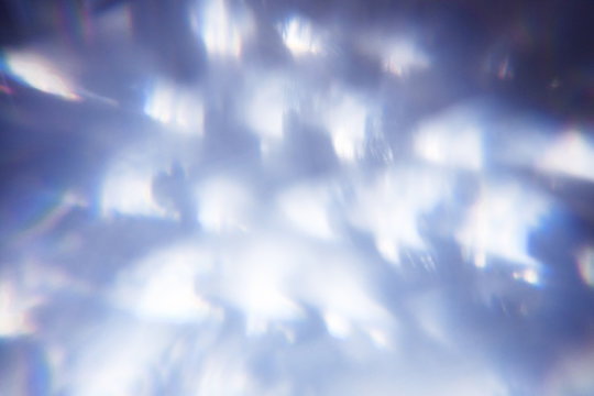 lens flare blurred defocused bright light blue background