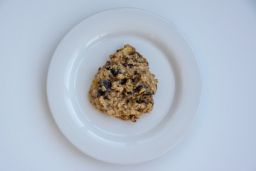 Homemade oatmeal cookies on plate on the white background. view from above.