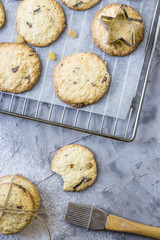 Homemade oatmeal cookies with chocolate chips on a gray kitchen table among accessories for baking. Top view, flat lay