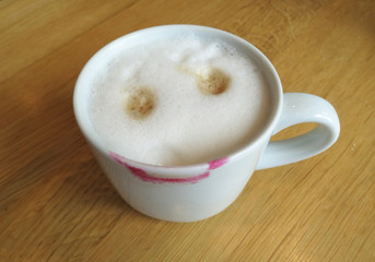 laughing  cappuccino with eyes and lipstick mouth