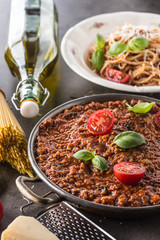 Classic italian bolognese sauce with ingredients pasta spaghetti olive oil tomatoes basil and parmesan cheese