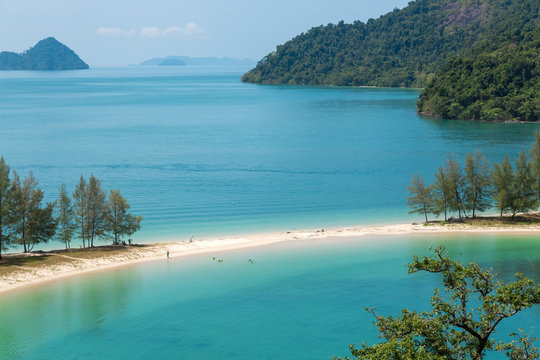 White sand beach and Long-tail boat at Kham-Tok Island (koh-kam-tok), The beautiful sea Ranong Province, Thailand.