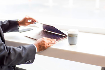 Asia business man working with laptop while sitting coffee shop .Concept of young  business people