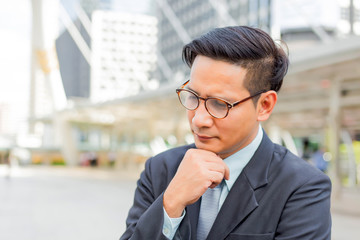 Young Asia handsome businessman thinking about his business