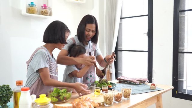 Mother And Daughter Cooking In The Kitchen At Home, Happy Family Asian Concept