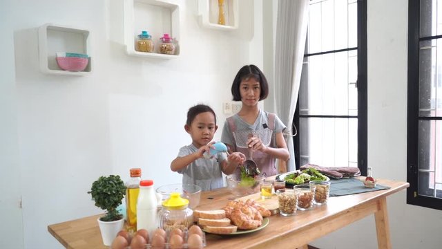 Two little girl cooks in the kitchen at home