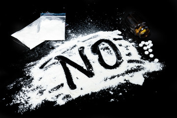 Drugs, syringe and pills. The inscription 