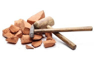 Shattered brick pieces and hammers isolated on white background