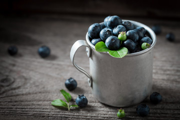 Tasty and fresh blueberry in the old metal mug