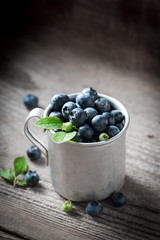 Juicy and fresh blueberry on old wooden rustic floor