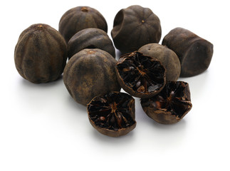 dried persian black lime, limu amani isolated on white background