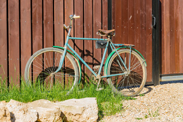 Old bicycle parked at a wooden fence, countrycide landscape