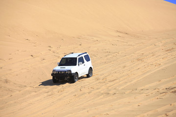An suv was driving in the desert. © zhengzaishanchu