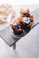 Delicious muffins with glaze on silver tray