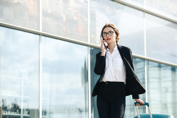 . Business woman at international airport moving to terminal gate for airplane travel trip - Mobility concept and aerospace industry flight connections